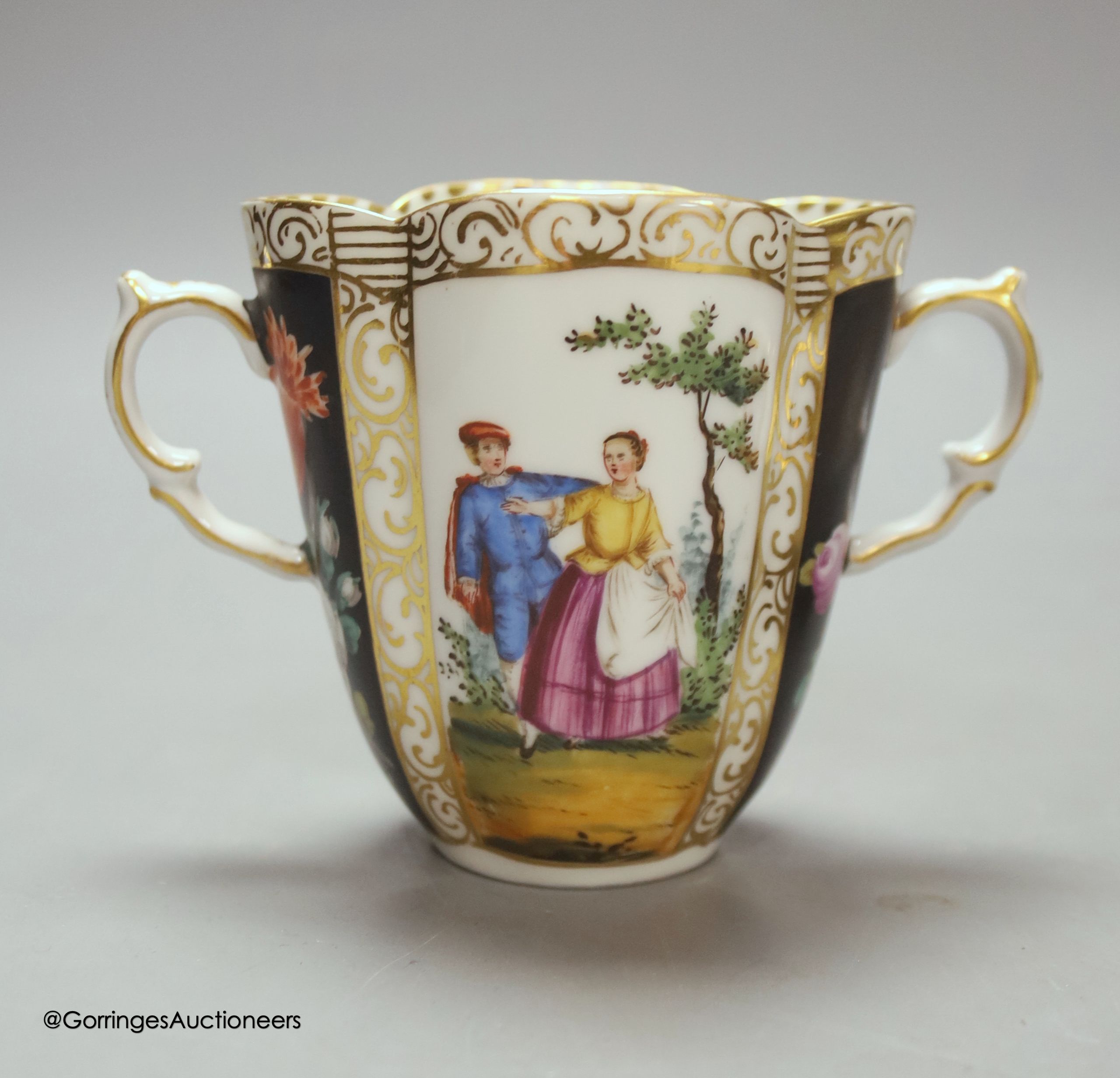 A Dresden two handled cup and saucer, height 8.5cm